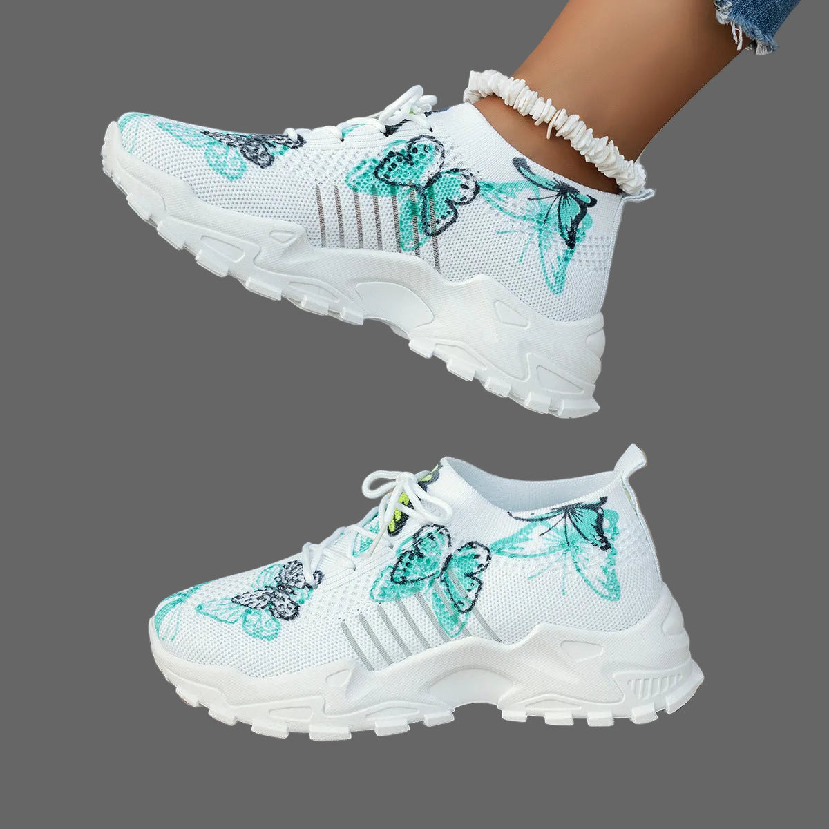 White sneakers with butterfly designs on a woven surface.