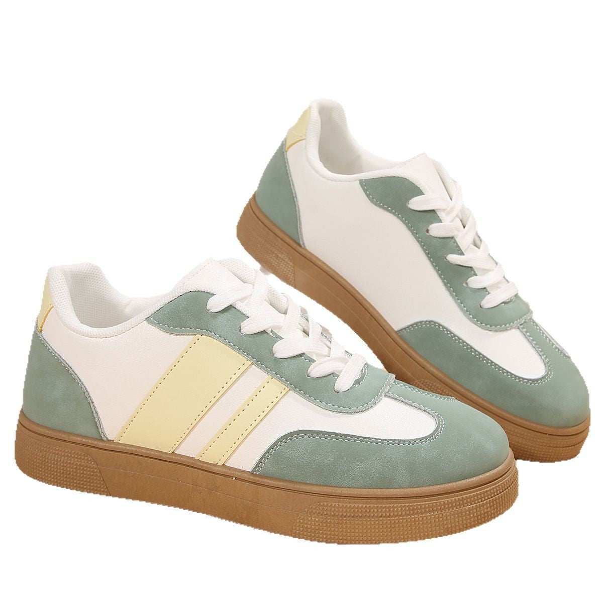 Pair of green and white sneakers with brown soles on a white background