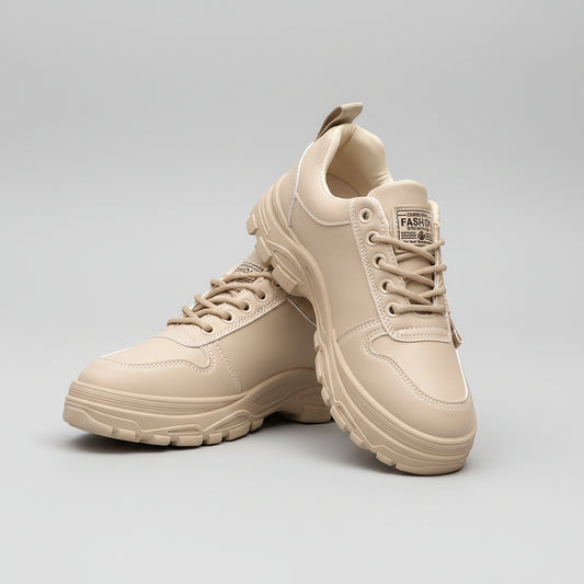 Beige sneakers worn with ripped jeans on a blurred street background