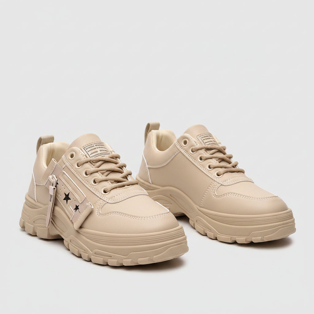 Beige sneakers worn with ripped jeans on a blurred street background